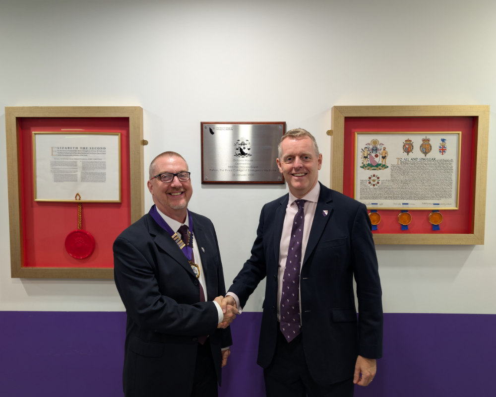 Dr Ian Higginson (left) is formally handed the presidency of RCEM by Dr Adrian Boyle (right).